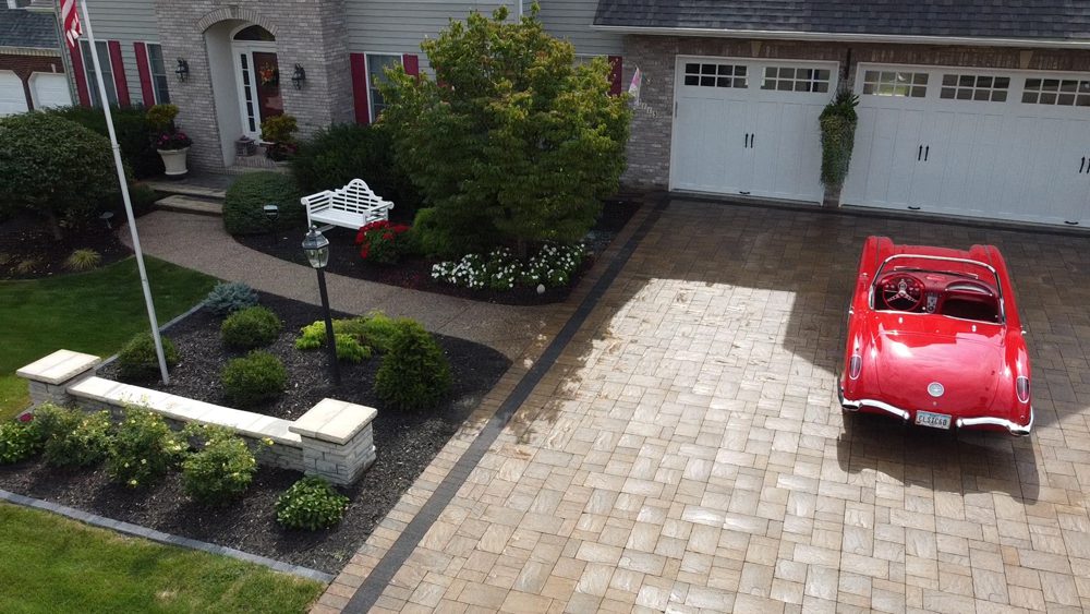 a walkway that leads to the driveway a walkway that leads to the driveway