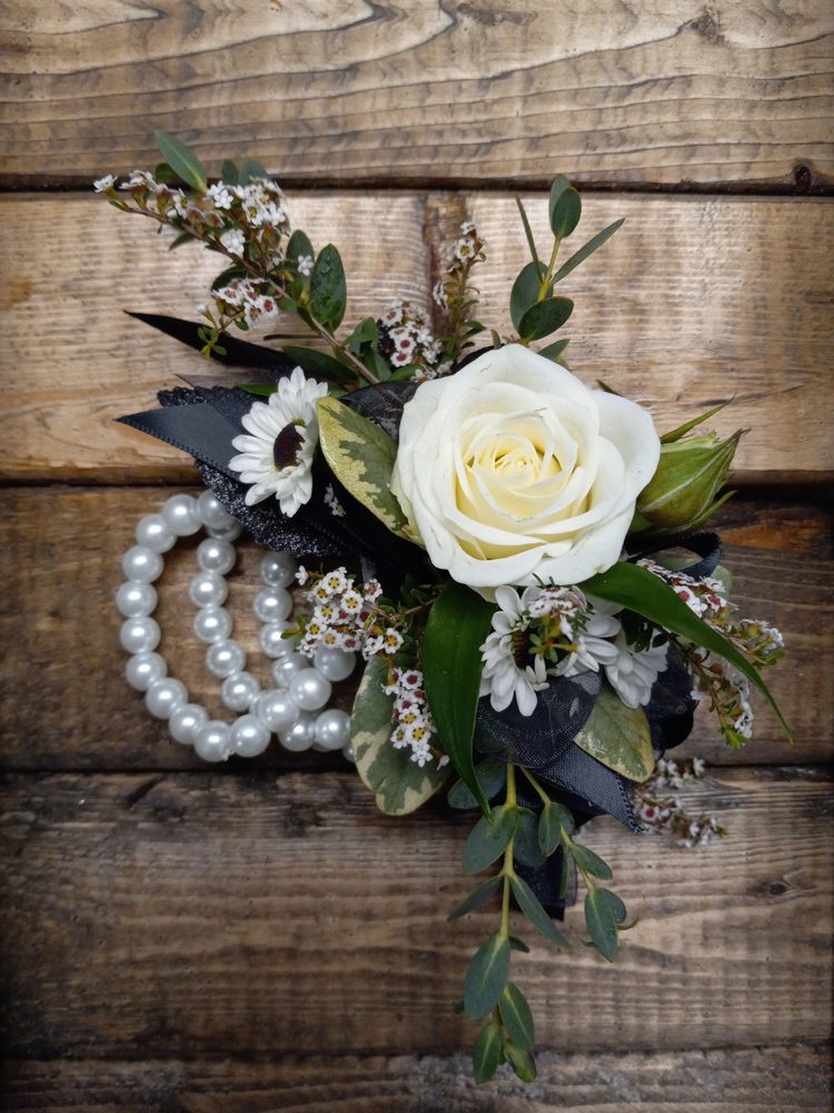 boutonniere with black ribbons and white pearls