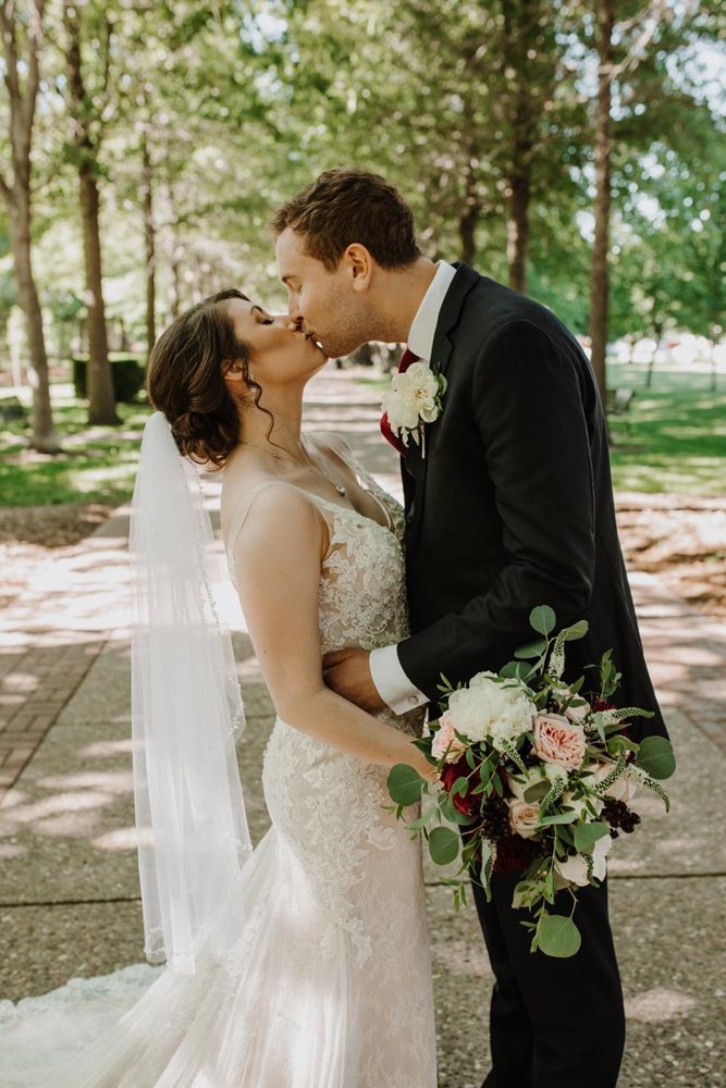 newlywed couple kissing with beautiful scenery as the background
