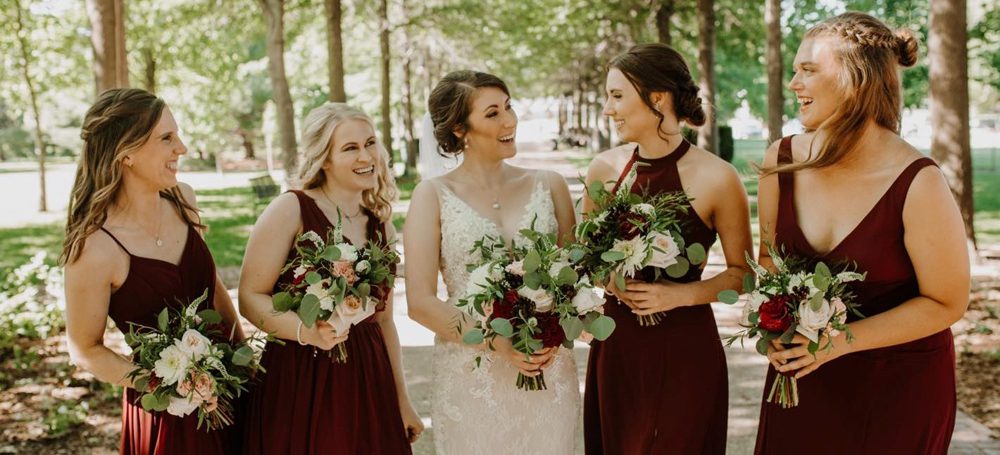 bride with her bridesmaid smiling and laughing together