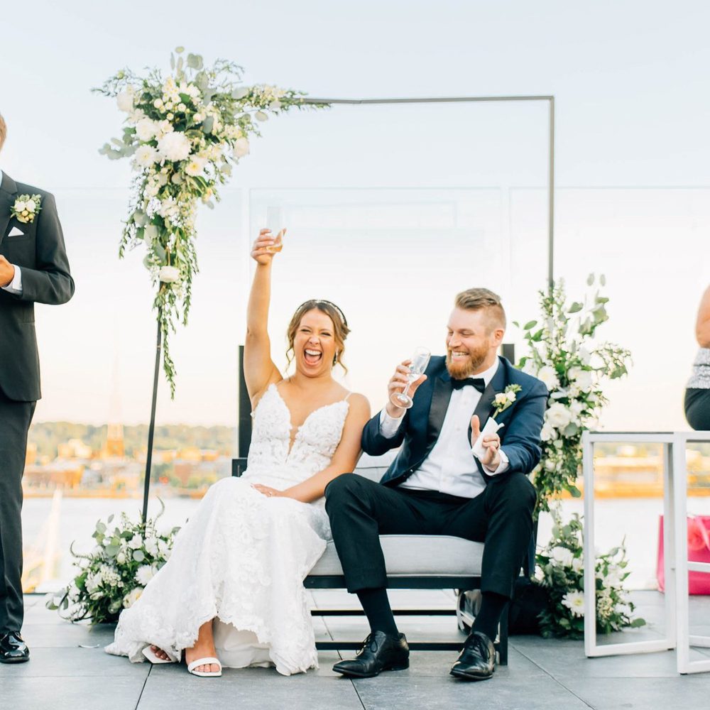 bride happily raising glass of wine
