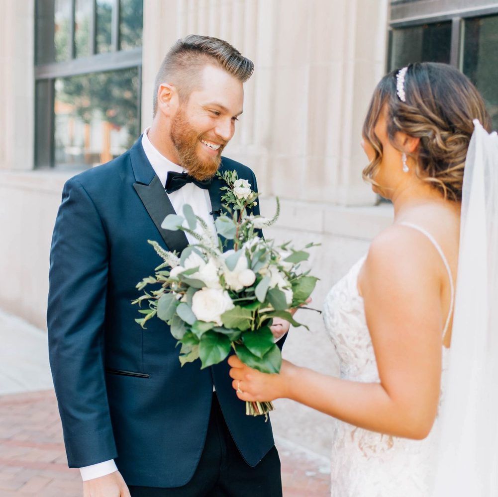 newlywed couple smiling with each other