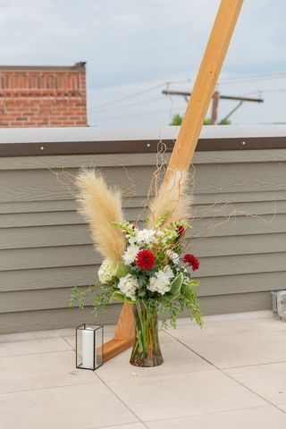 flowers on a base with a white candle