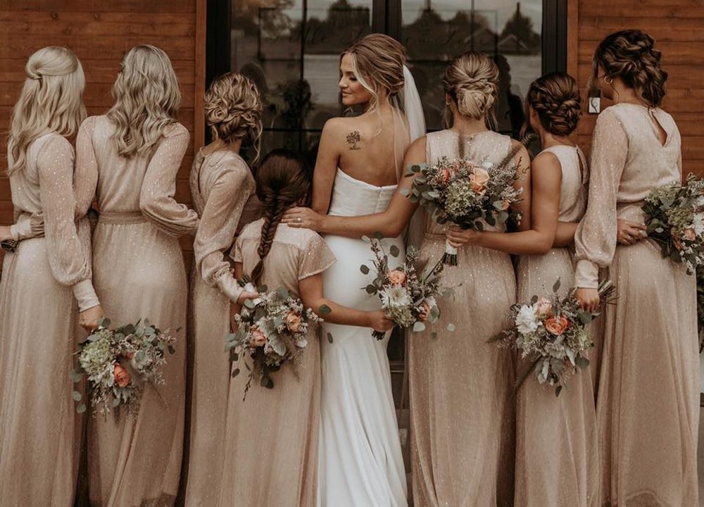 bride with her bridesmaid wearing beige dress