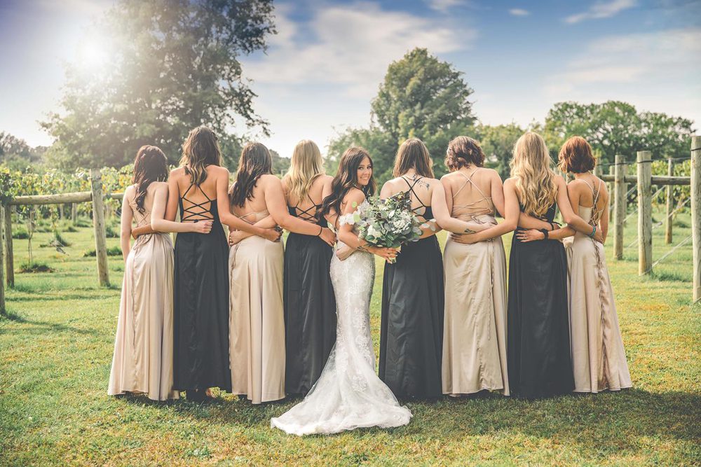 bridesmaid lined up with the bride looking back at the photographer