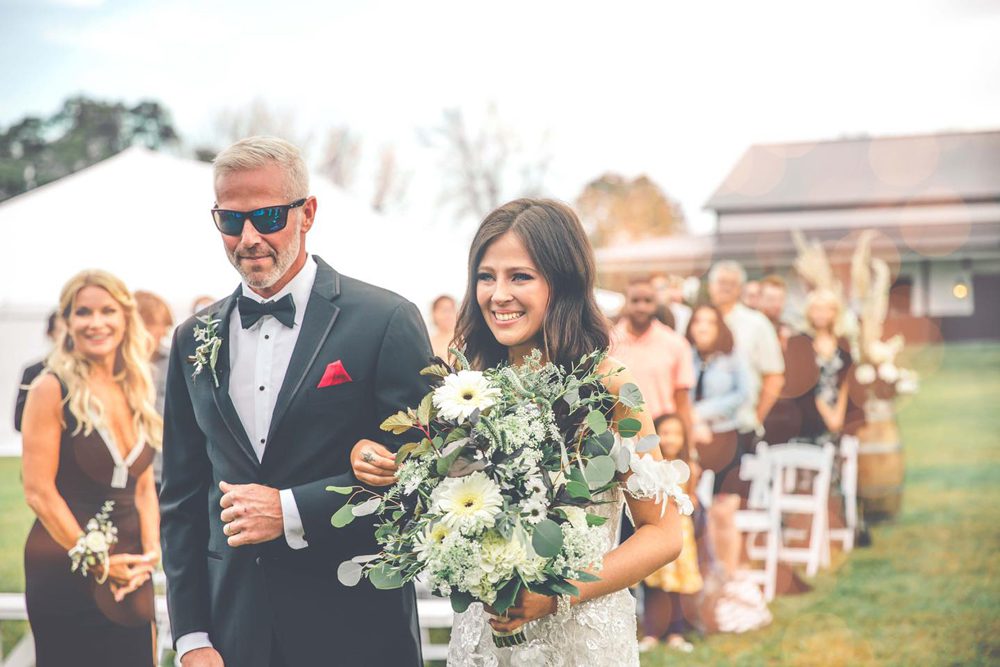 father walking down the aisle with his daughter
