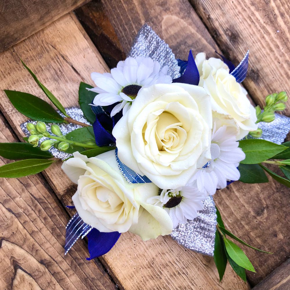boutonniere placed on a wooden table boutonniere placed on a wooden table