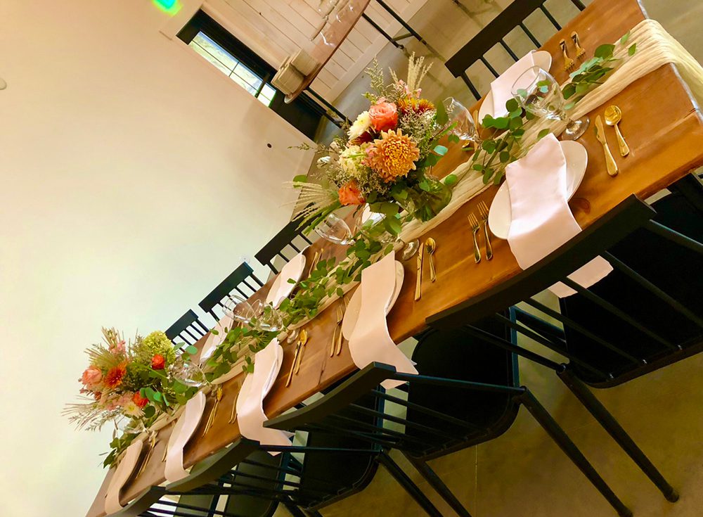 table setting with two bouquet of flowers in a clear base