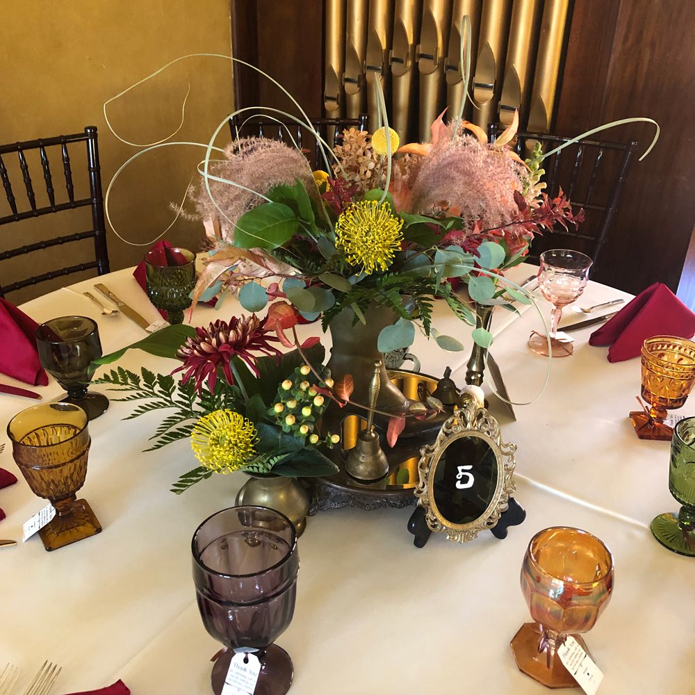 table settings with fall-themed flowers arrangement