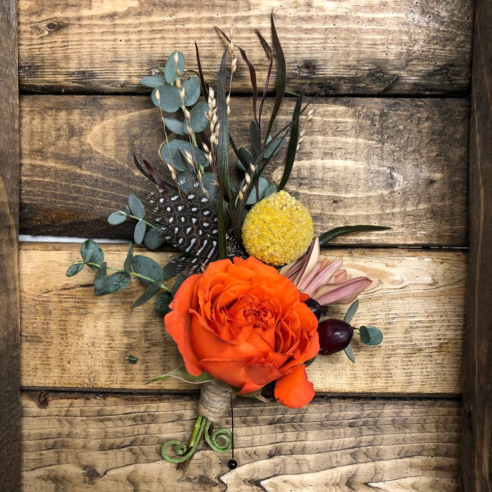 boutonniere with bird feathers