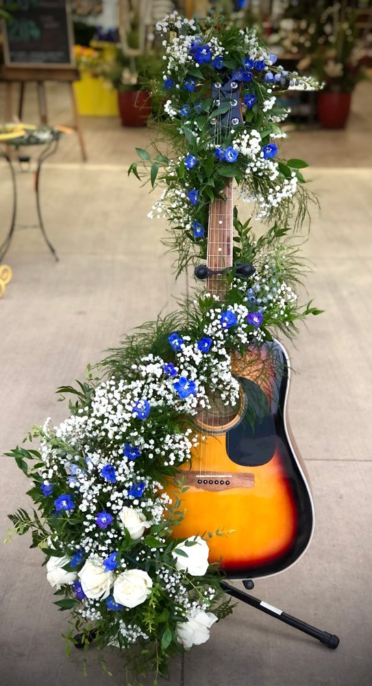 guitar with flowers wrapped around it