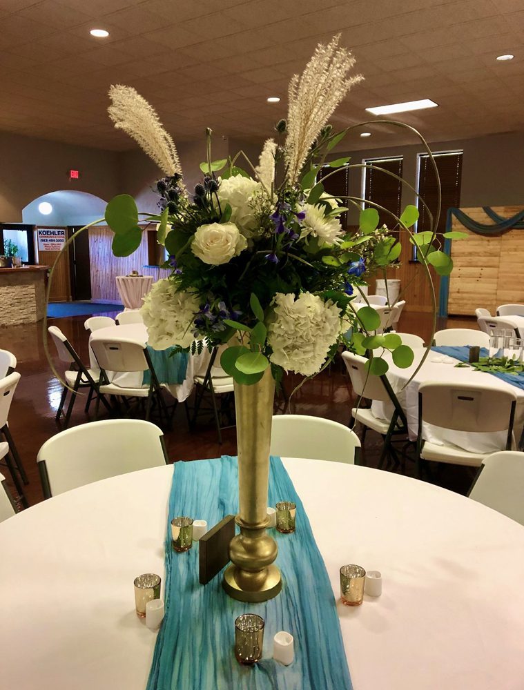 a closeup look of bouquet with white flowers in a metallic base