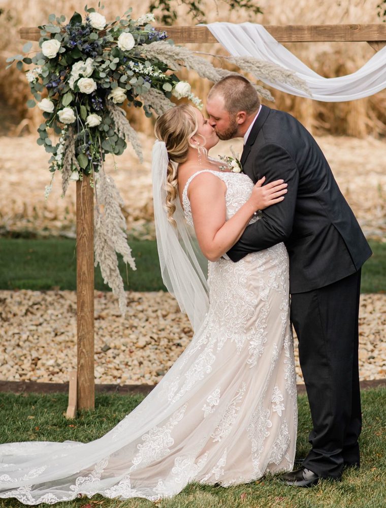 bride and groom kissing at the wedding ceremony stage